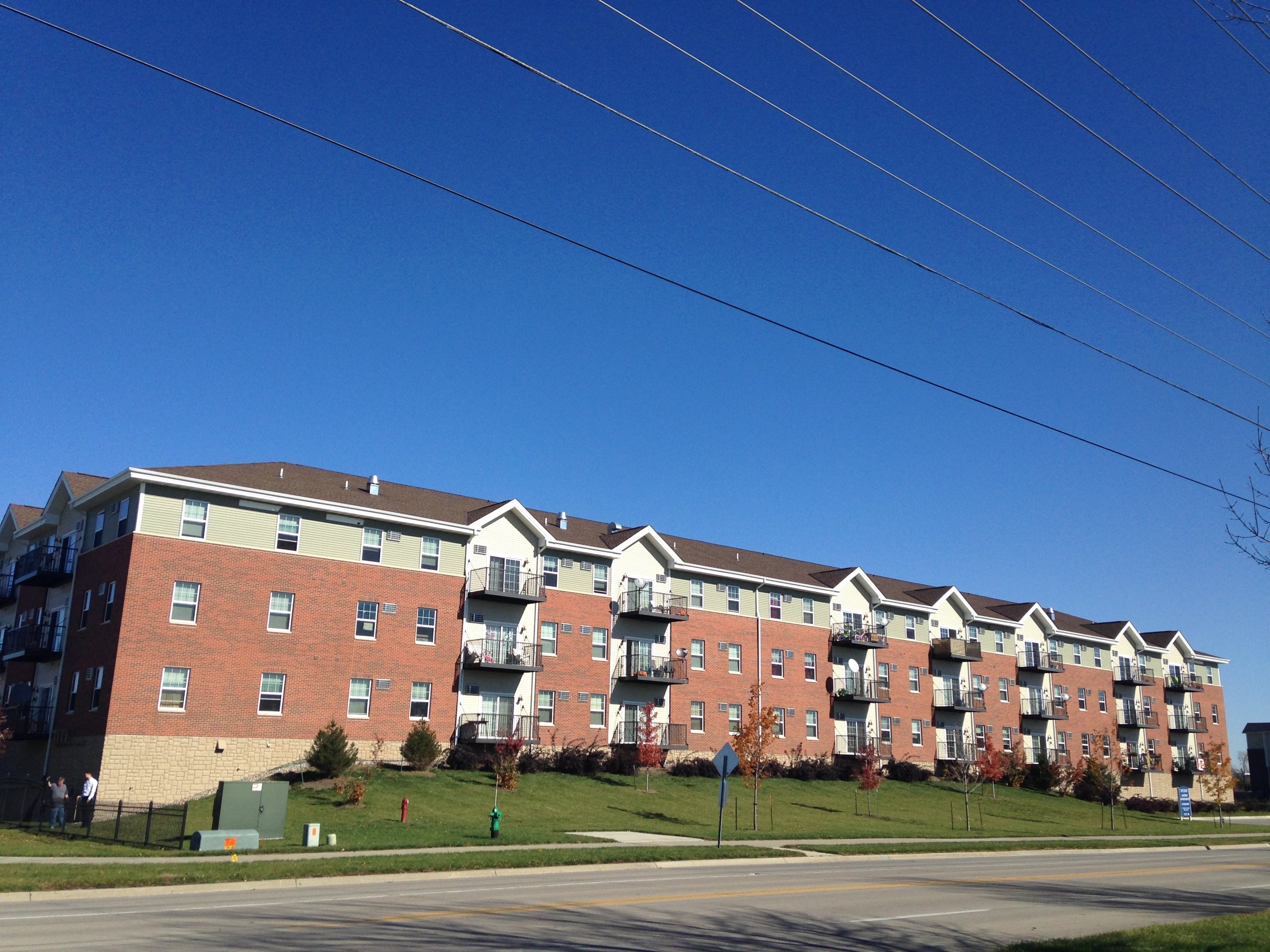Apartment building with red brick and white trim.,Apartment building with red brick and white trim.